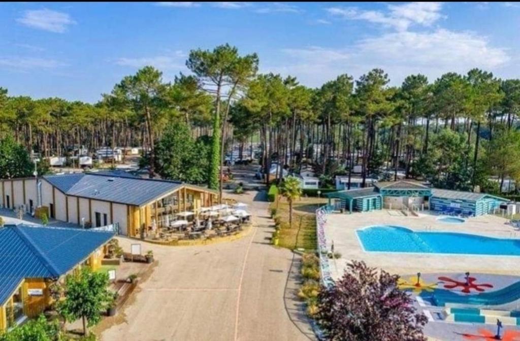 an aerial view of a resort with a swimming pool at Camping des Dunes de Contis mobilhome 3ch, in Saint-Julien-en-Born