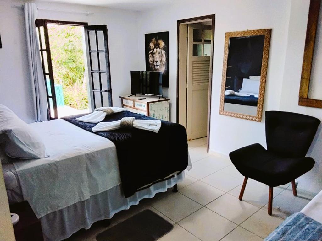 a bedroom with a bed and a chair at Shanti Life in Búzios