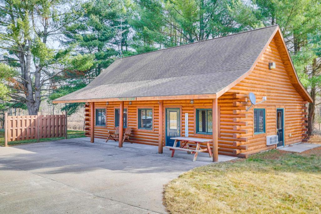 uma cabana de madeira com uma mesa de piquenique no quintal em Black River Log Cabin Fish, Swim and Unwind! em Hatfield