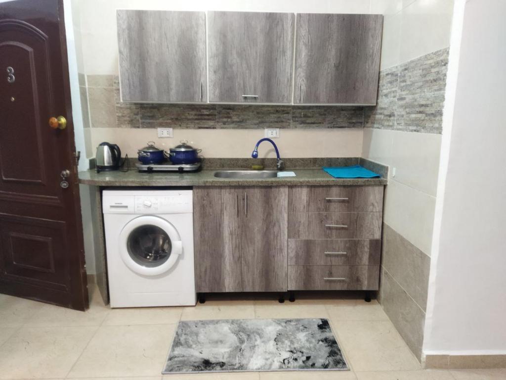 a kitchen with a sink and a washing machine at Hurghada City Apartment 3 in Hurghada