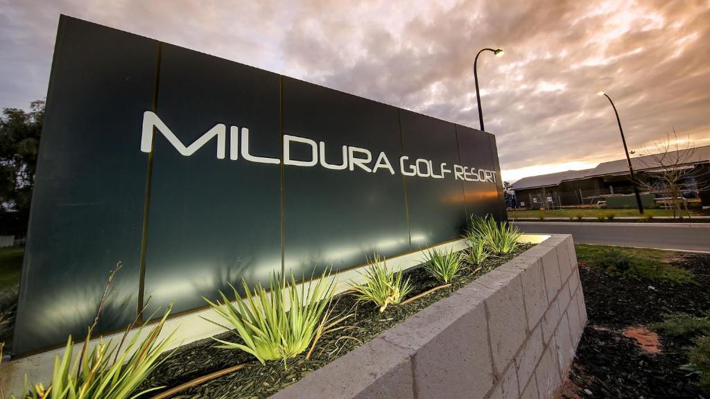 a large sign for a millipede company on the side of a road at Mildura Golf Resort in Mildura