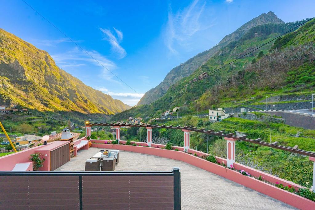 a view from the balcony of a resort with mountains at Du.Val - Madeira Valley Villa in Ribeira Brava