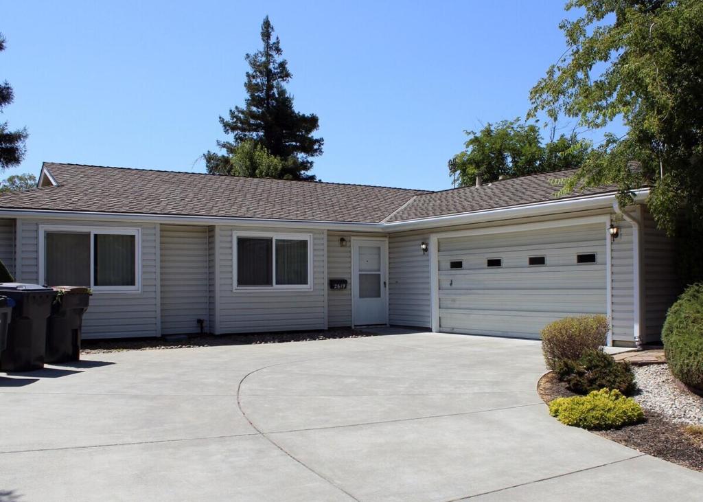 a house with a driveway and a garage at Tomodachi House - The Perfect Getaway for All! in Davis