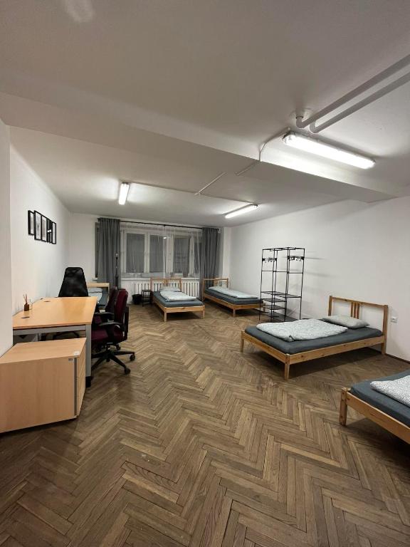 a room with three beds and a desk at Nice flat in City Center Kraków in Krakow