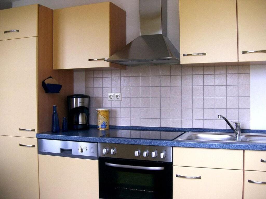a kitchen with a stove and a sink at Holiday apartment "Kati" in Lancken-Granitz