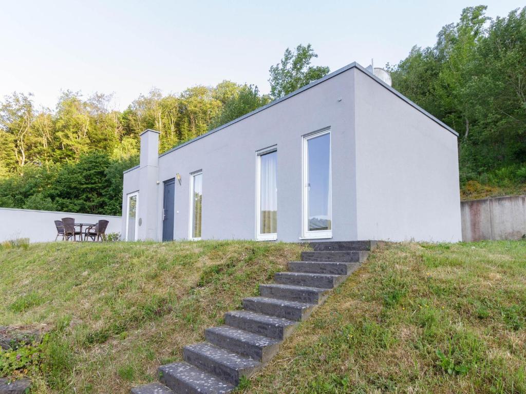 a white house on a hill with stairs at Beautiful holiday home in Waxweiler in the Eifel in Waxweiler