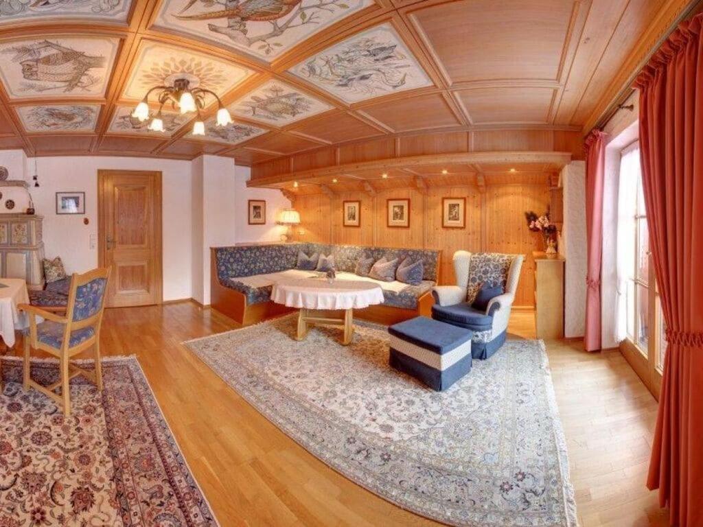a living room with a couch and a table at Staufenblick roof studio in the house in Inzell