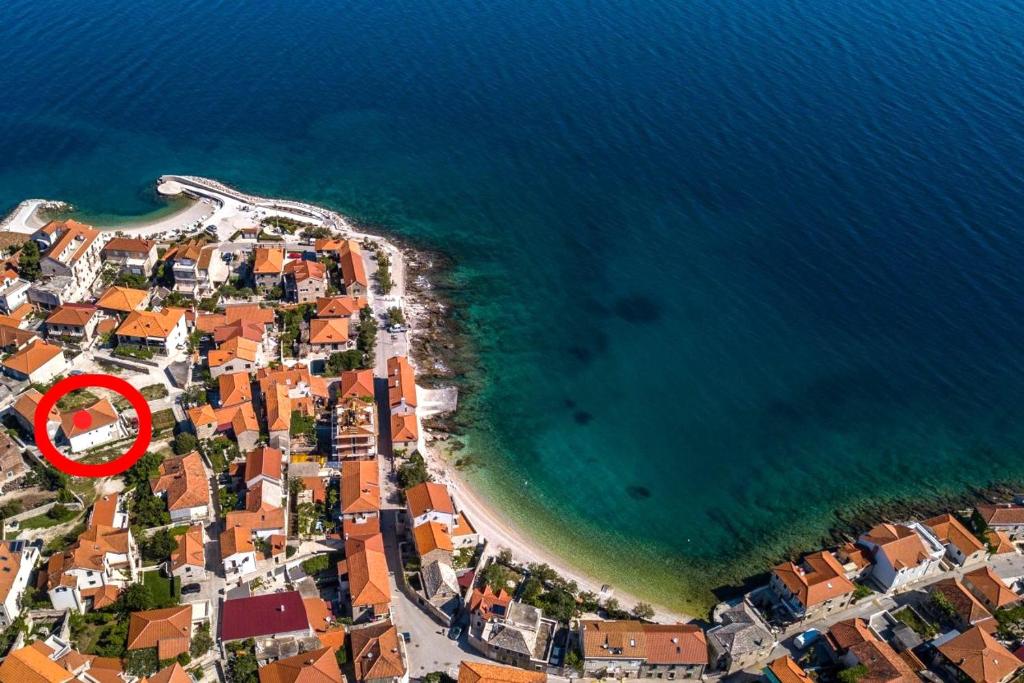 an aerial view of a beach with a red circle at Apartments by the sea Postira, Brac - 12291 in Postira
