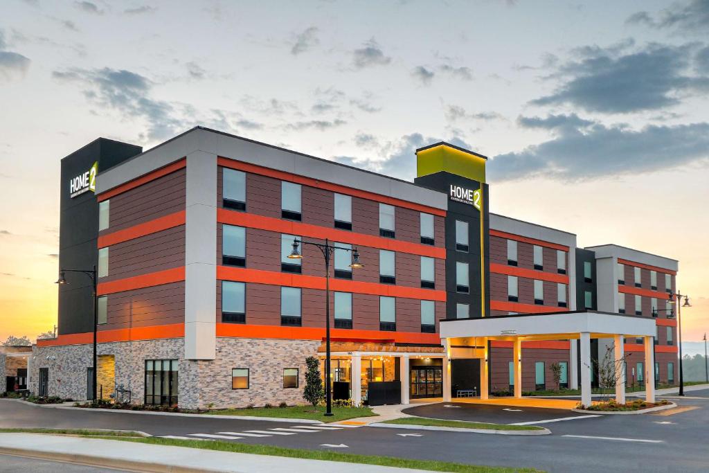 a large building with a hotel on the street at Home2 Suites By Hilton Alcoa Knoxville Airport in Alcoa