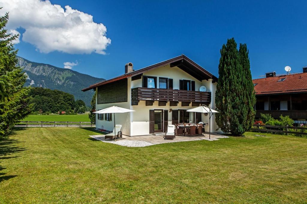 a house with a large yard in front of it at Ferienhaus Balsbergblick in Unterwössen