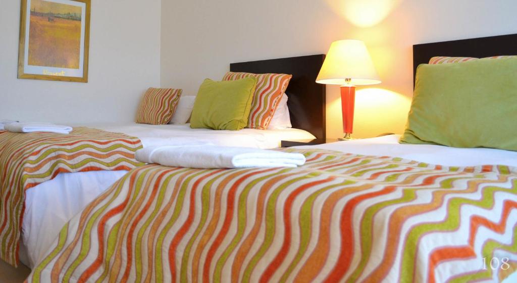Postel nebo postele na pokoji v ubytování Hotel Quinto Elemento