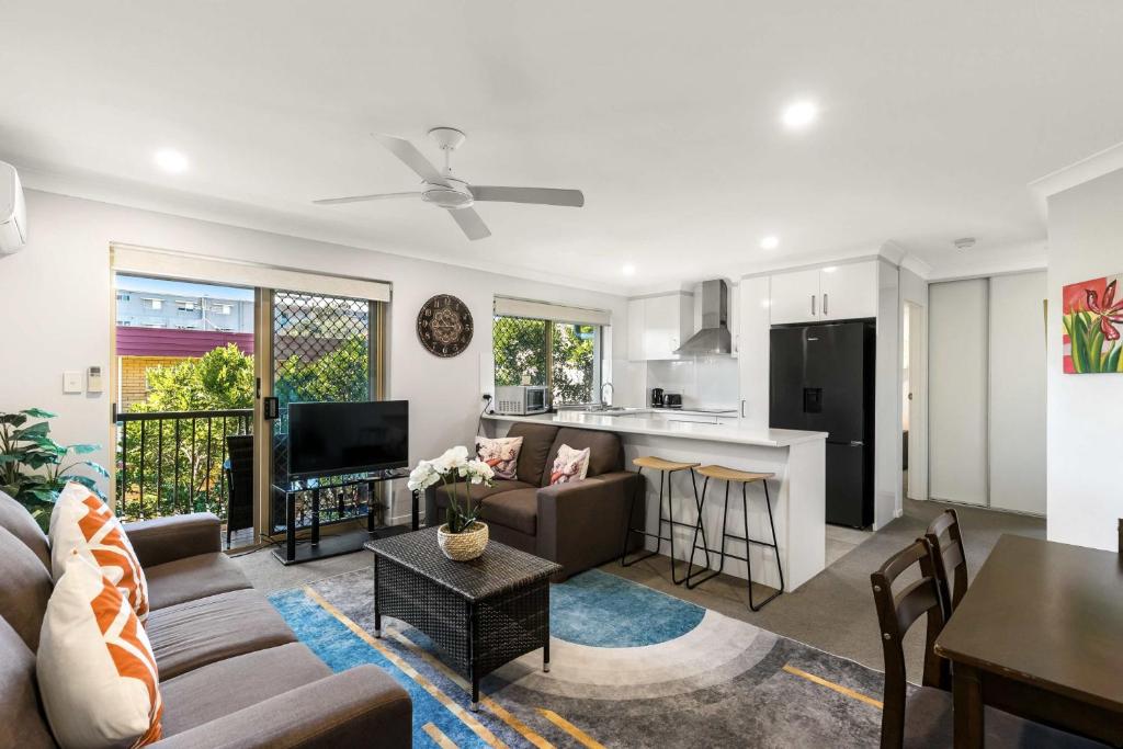 a living room with a couch and a table at Charming 3-bed Apartment near Local Shops in Brisbane
