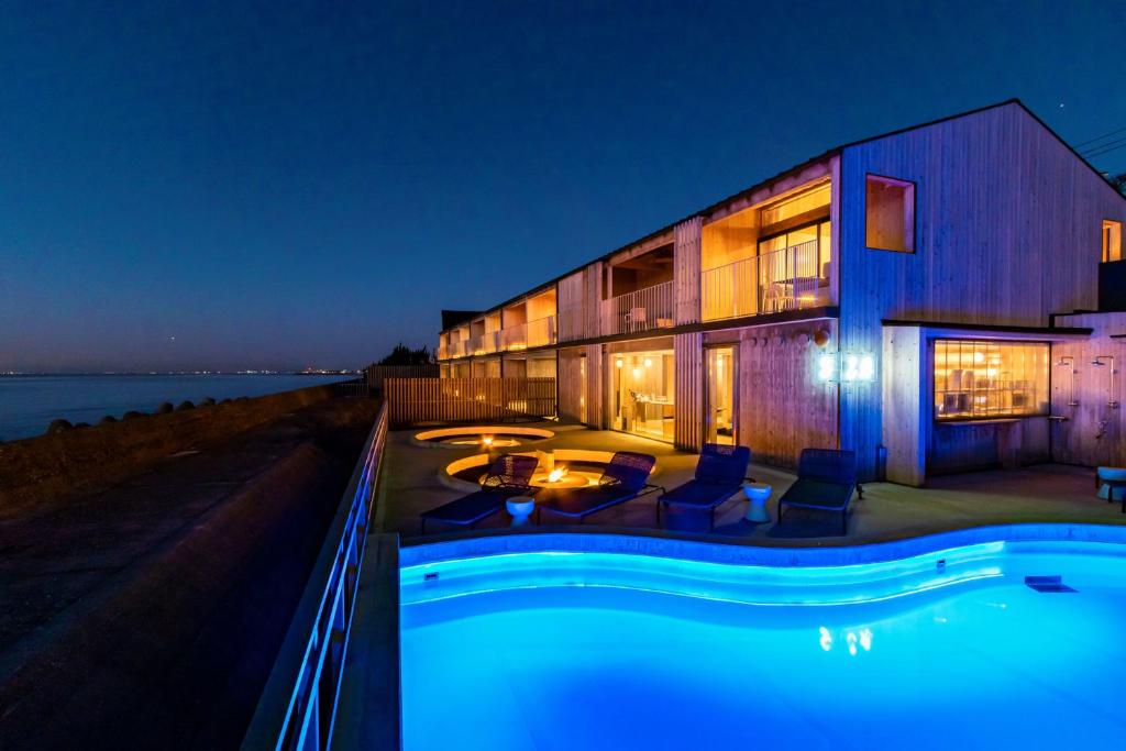 a house with a swimming pool at night at KAMOME SLOW HOTEL in Awaji