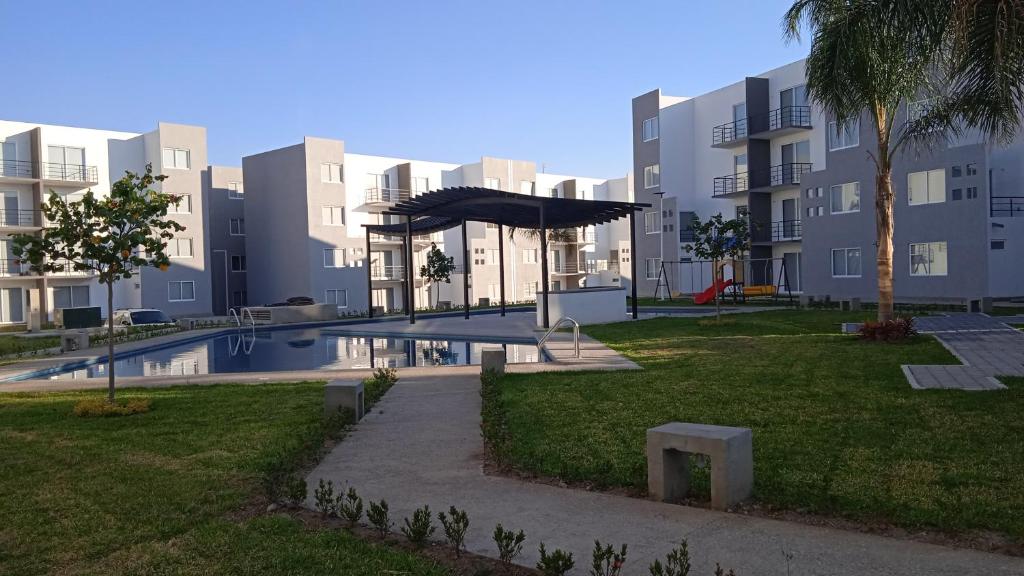 a large apartment complex with a swimming pool in a park at Yecapixtla in Yecapixtla