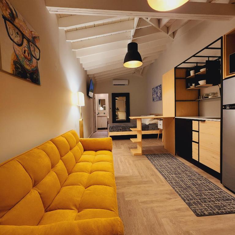 een woonkamer met een gele bank en een keuken bij Private Home Studio Central Located in Miami 1 in Opa-locka