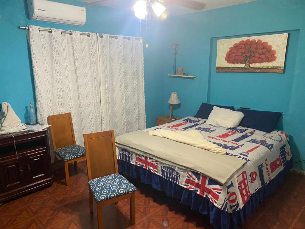 a bedroom with a bed and a table and chairs at Habitación a media cuadra de la playa. in Mazatlán