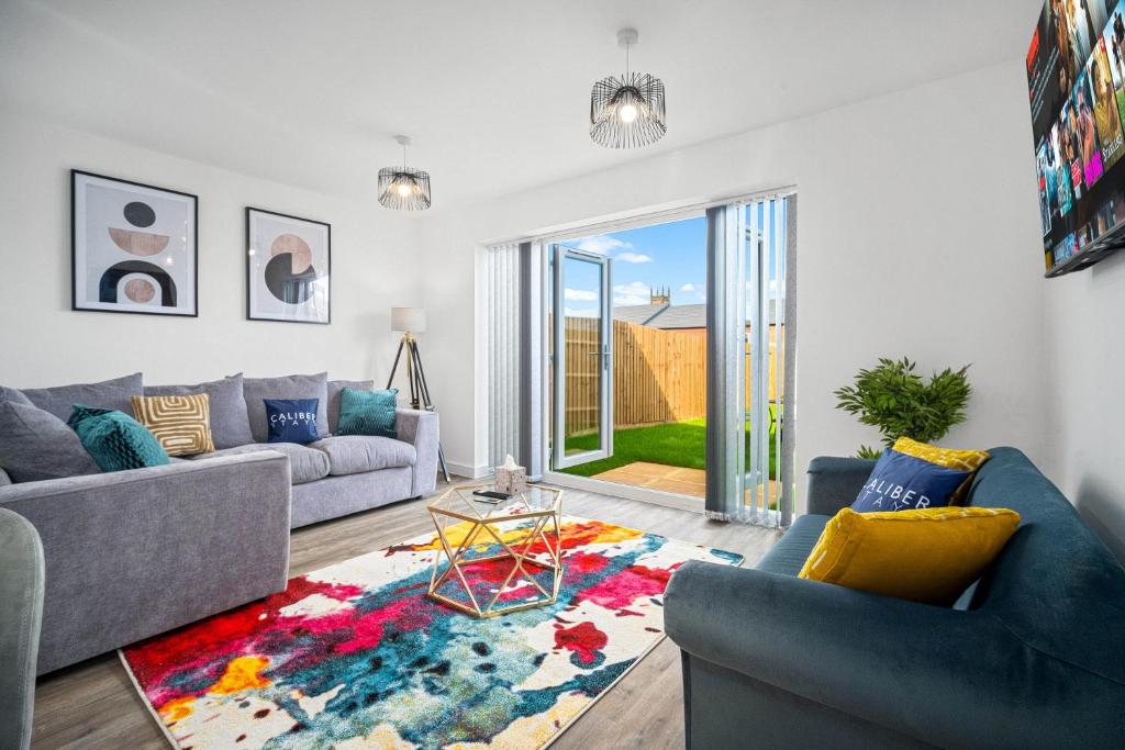 a living room with two couches and a rug at CALIBER STAYS® Serviced Homes Collection - Serviced Houses Derby City Centre - Ideal Contractors & Family Choice in Derby