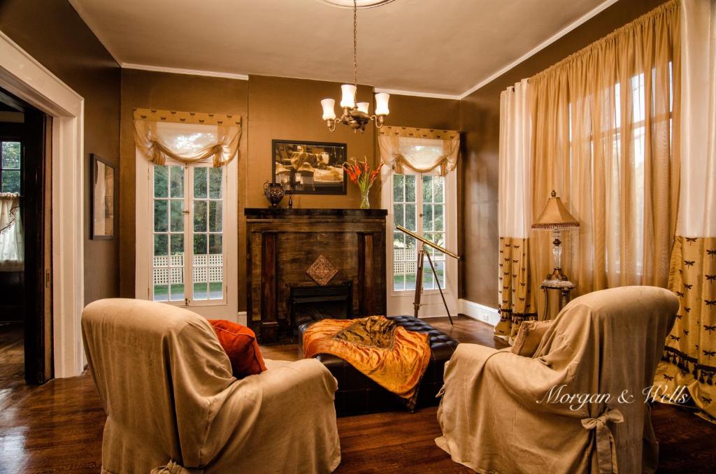 謝爾比的住宿－Morgan and Wells Bed and Breakfast，客厅配有两把椅子和壁炉