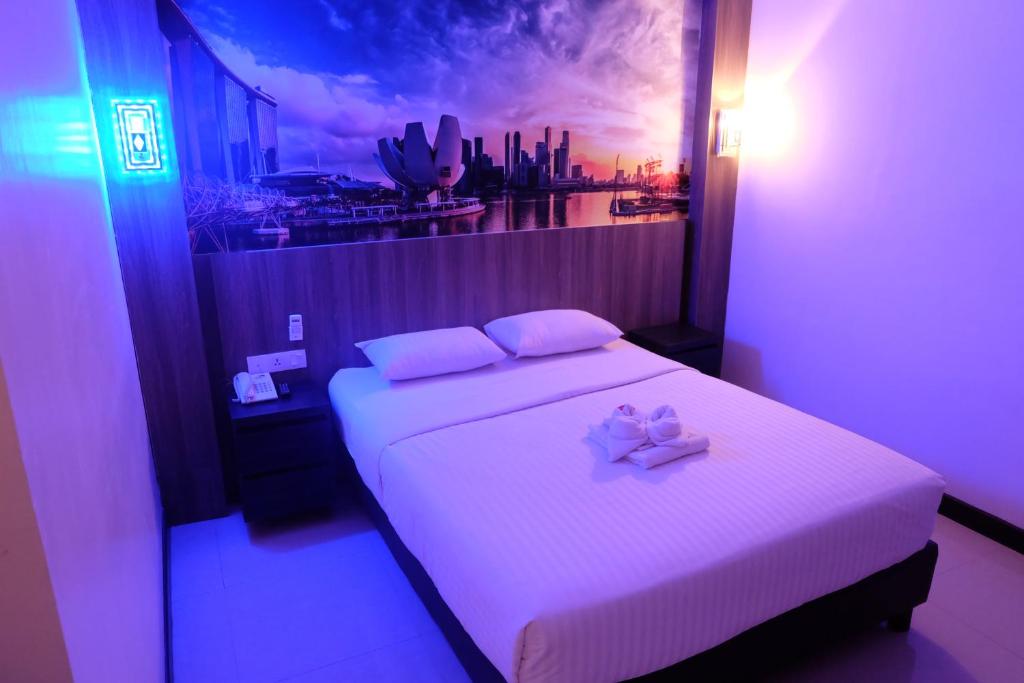 Un dormitorio con una cama con dos arcos rosados. en HOTEL MY HOME en Sintang