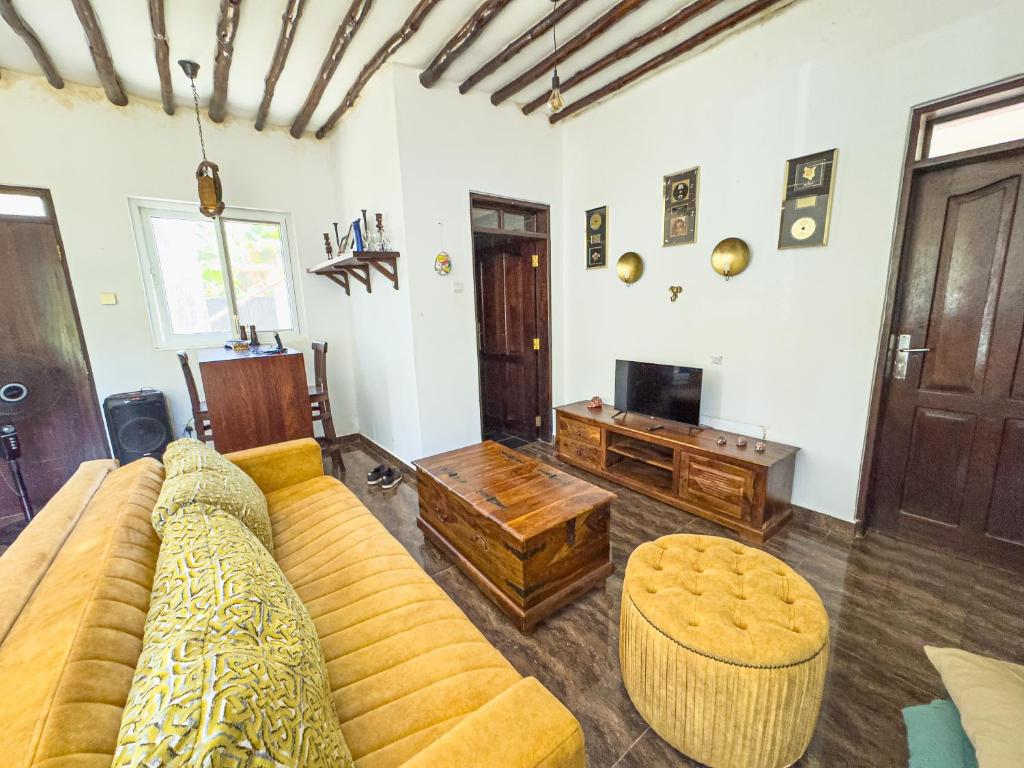 a living room with a couch and a table at Ring Residence Guesthouse in Diani Beach