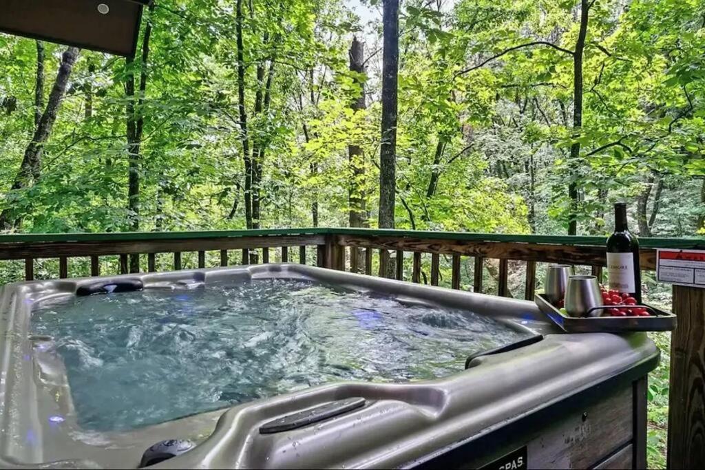 a jacuzzi tub on a deck in the woods at Beary Peaceful Smokies Retreat: Hot-Tub & Pools in Pigeon Forge