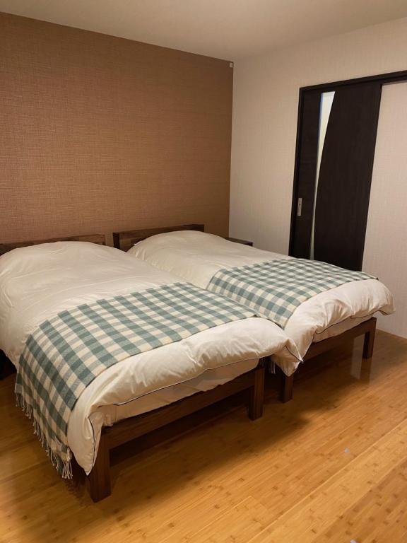 Postel nebo postele na pokoji v ubytování The Address Akakura