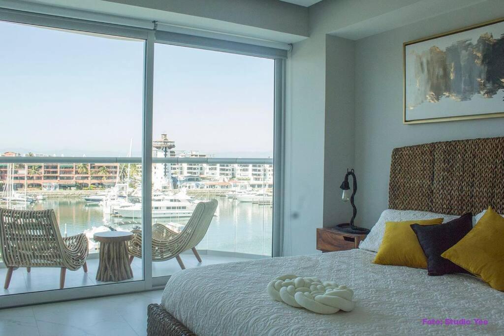 a bedroom with a bed with a view of a marina at Best View in Marina puerto Vallarta in Puerto Vallarta