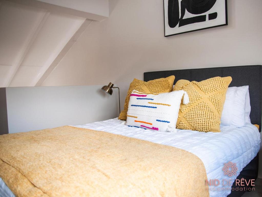 a bedroom with a bed with yellow and white pillows at Nid de Rêve Accomodation in Sandton