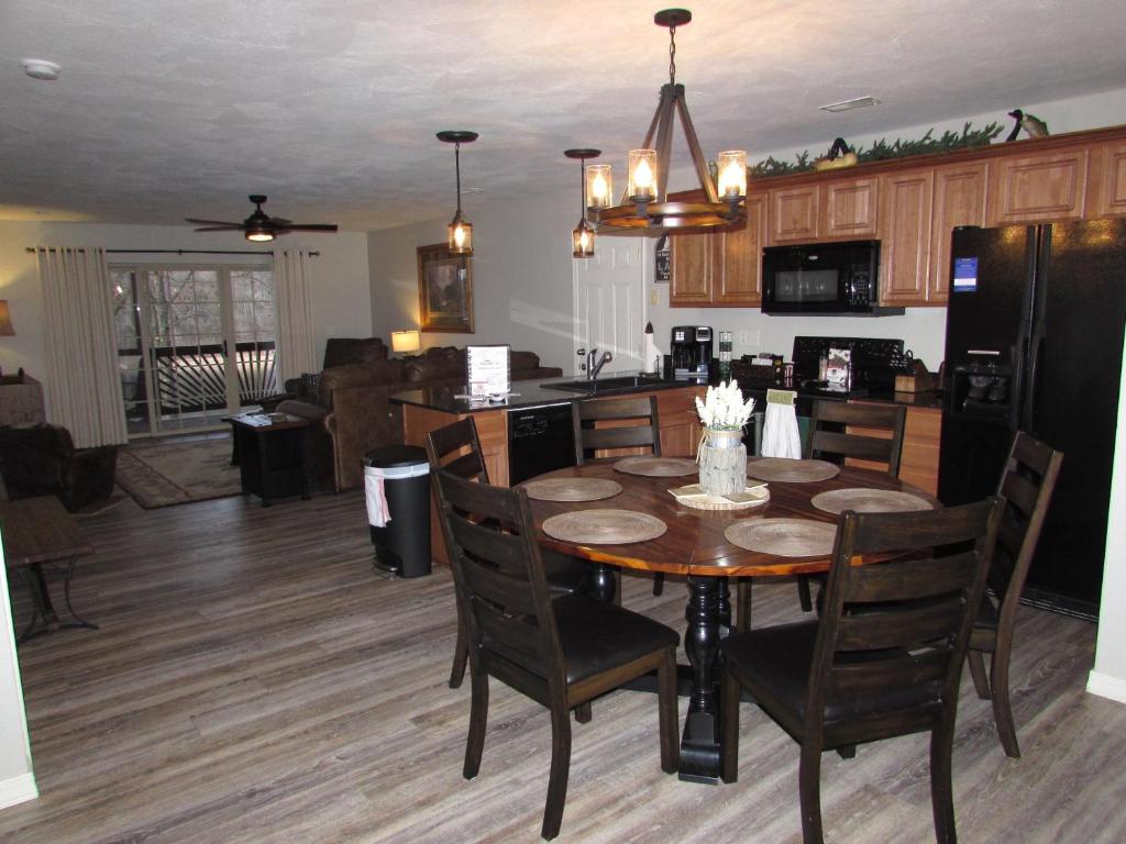 a kitchen and dining room with a table and chairs at Lakefront Condo A-1 with Large Balcony in Hollister