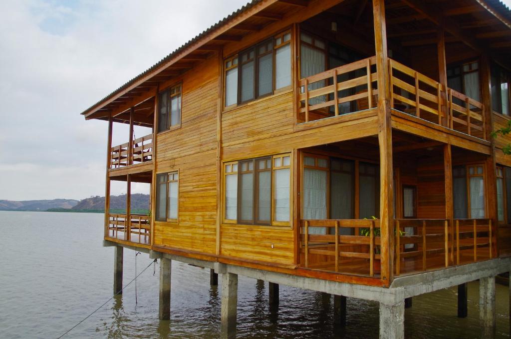 a wooden house on a dock in the water at Saiananda Adventure Eco Lodge in Bahía de Caráquez