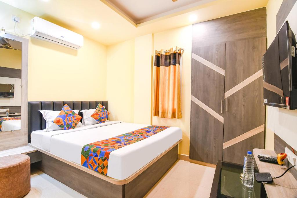 a bedroom with a large bed in a room at FabHotel Bypass View in Kolkata