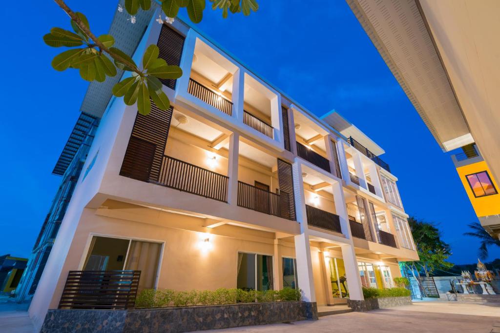 an apartment building with lights on at night at The Bua Boutique Resort in Ban Huai Krabok