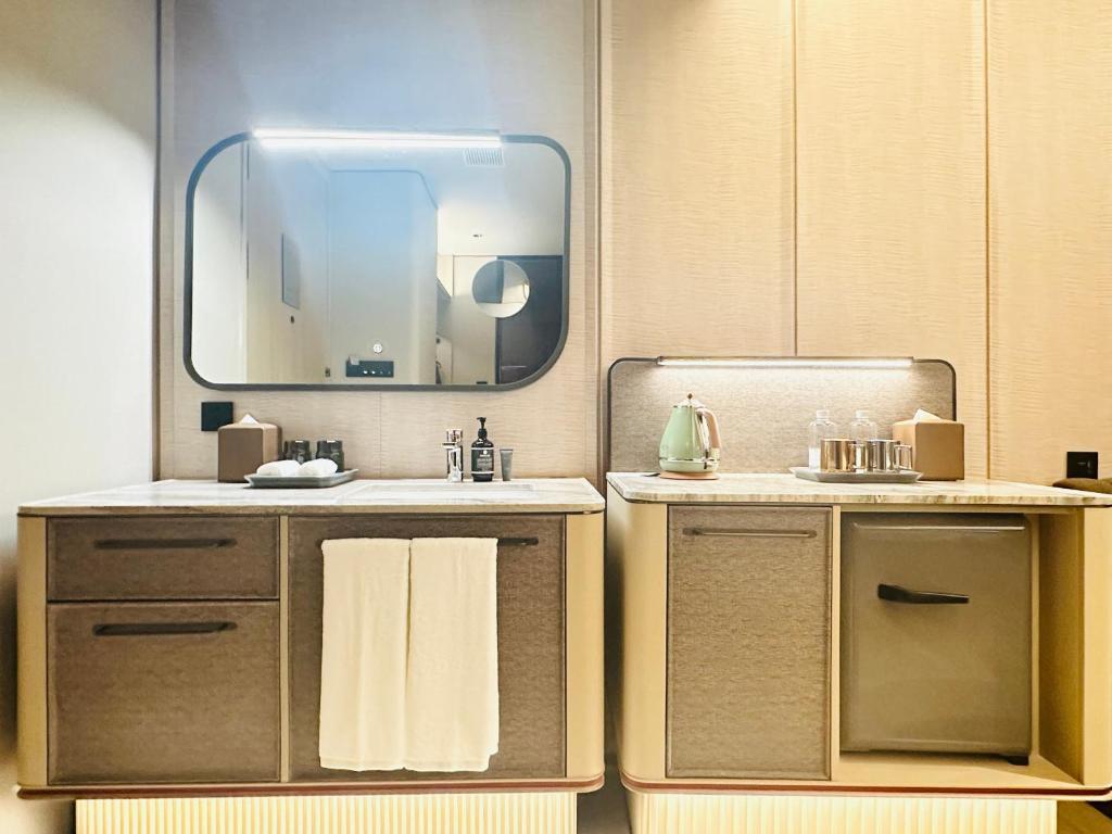 a bathroom with a sink and a mirror at IntercityHotel Shanghai Hongqiao Airport - Free Minibar for First Night in Shanghai