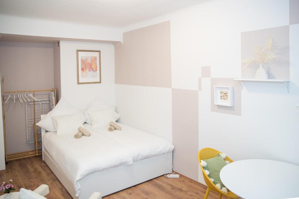 a bedroom with a white bed with teddy bears on it at Cozy City Apartments in center K28 in Vienna