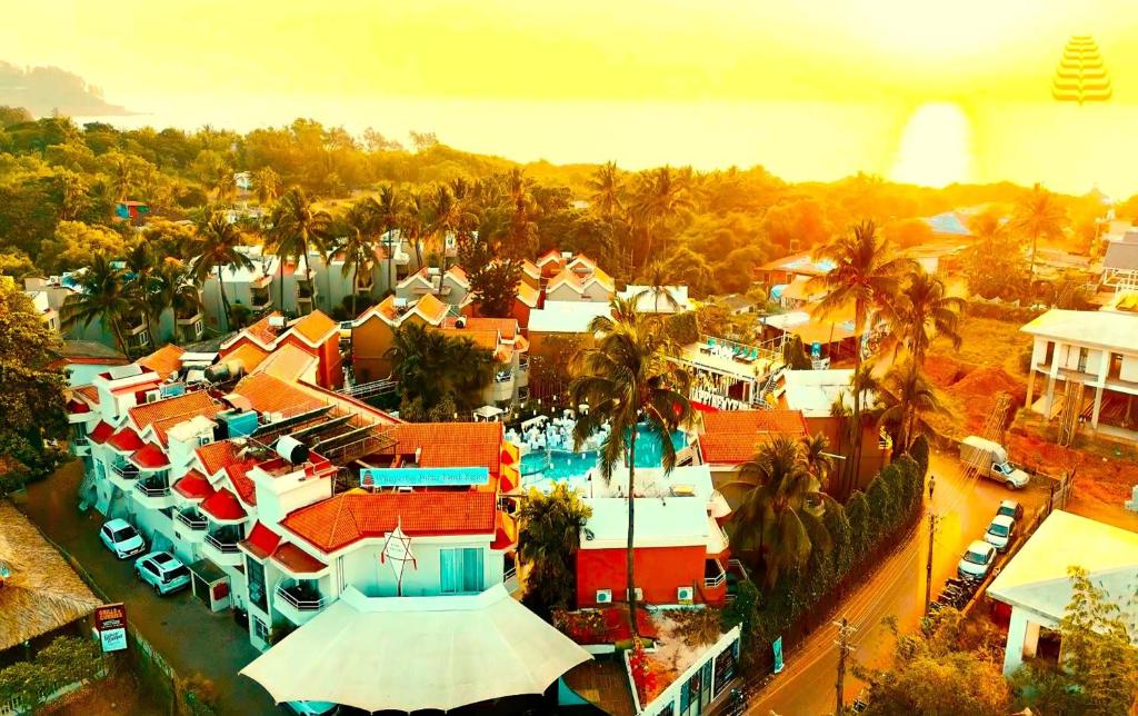 an aerial view of a resort with a pool at Whispering Palms Beach Resort in Candolim