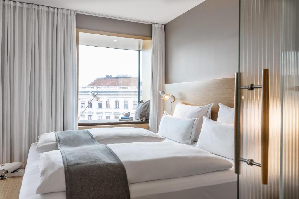 Posteľ alebo postele v izbe v ubytovaní The Guesthouse Vienna