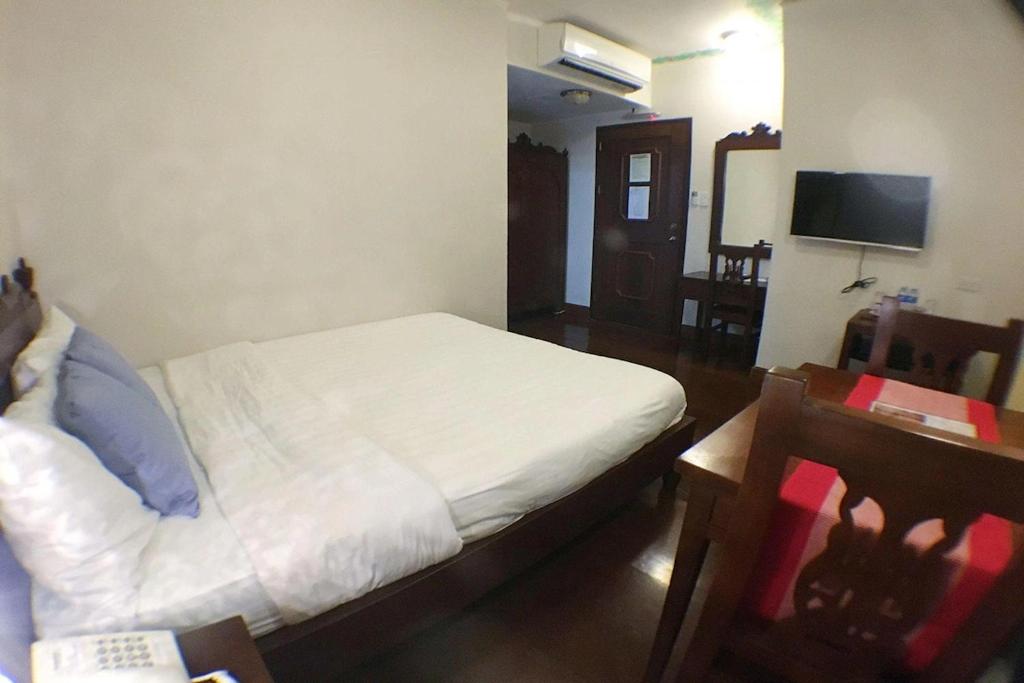 Postel nebo postele na pokoji v ubytování NSCC Hotel Vigan