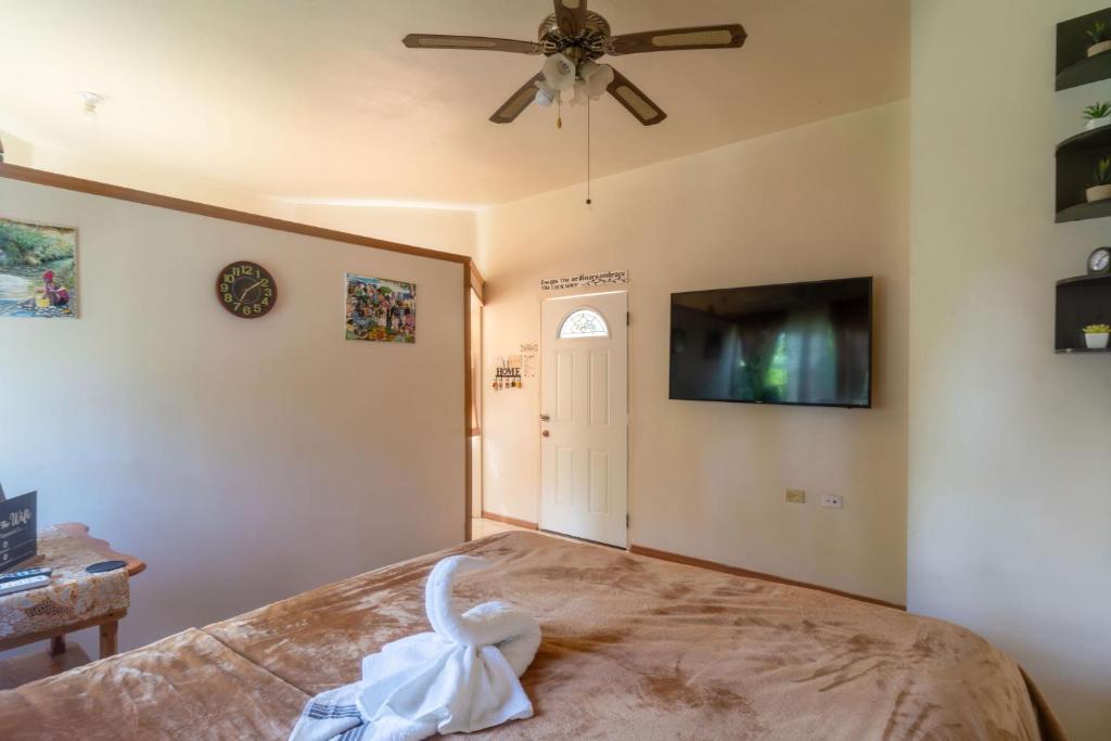 a bedroom with a bed and a ceiling fan at Eleven30 Luxury Apartment 2B in Negril