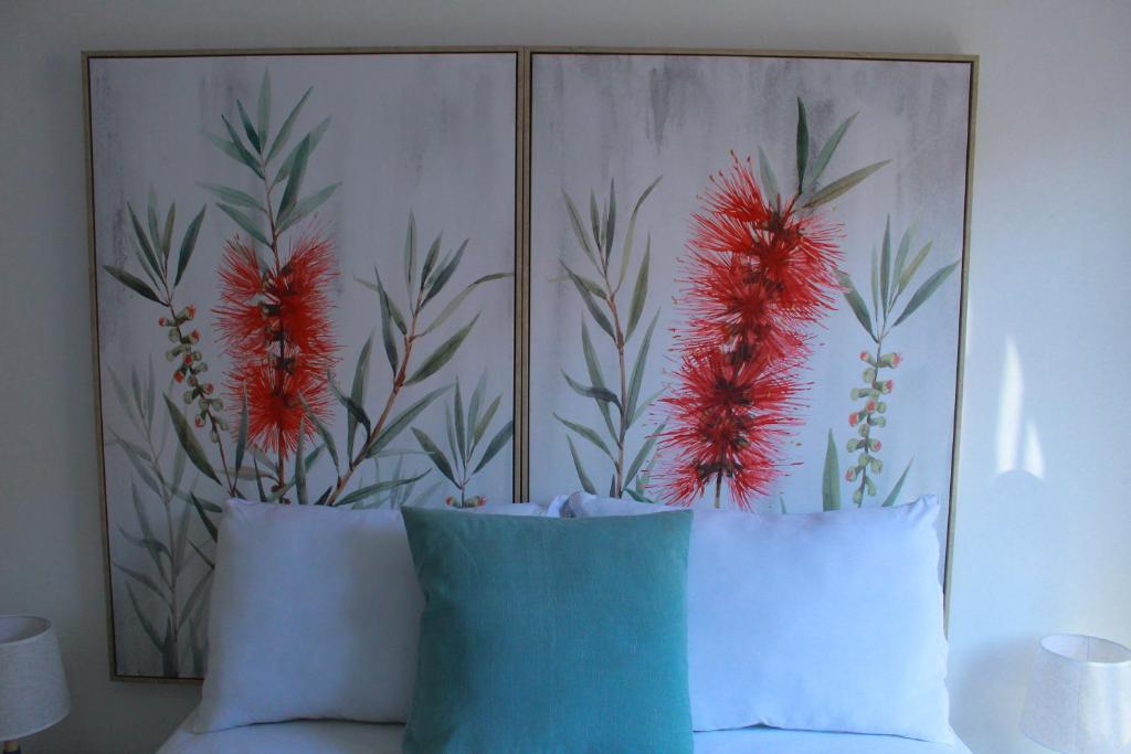 a headboard of a bed with red flowers on it at Gaborone 1 bed suburban bliss in Gaborone