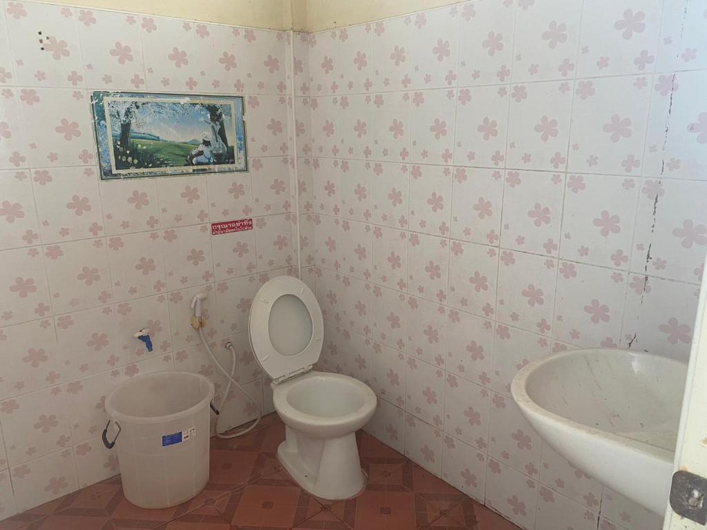 a bathroom with a toilet and a sink at CTM.INN (SISAKET)THAILAND 