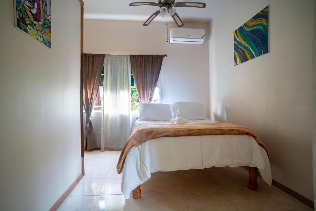 a bedroom with a bed with two laptops on it at Eleven30 Luxury Apartment 1B in Negril