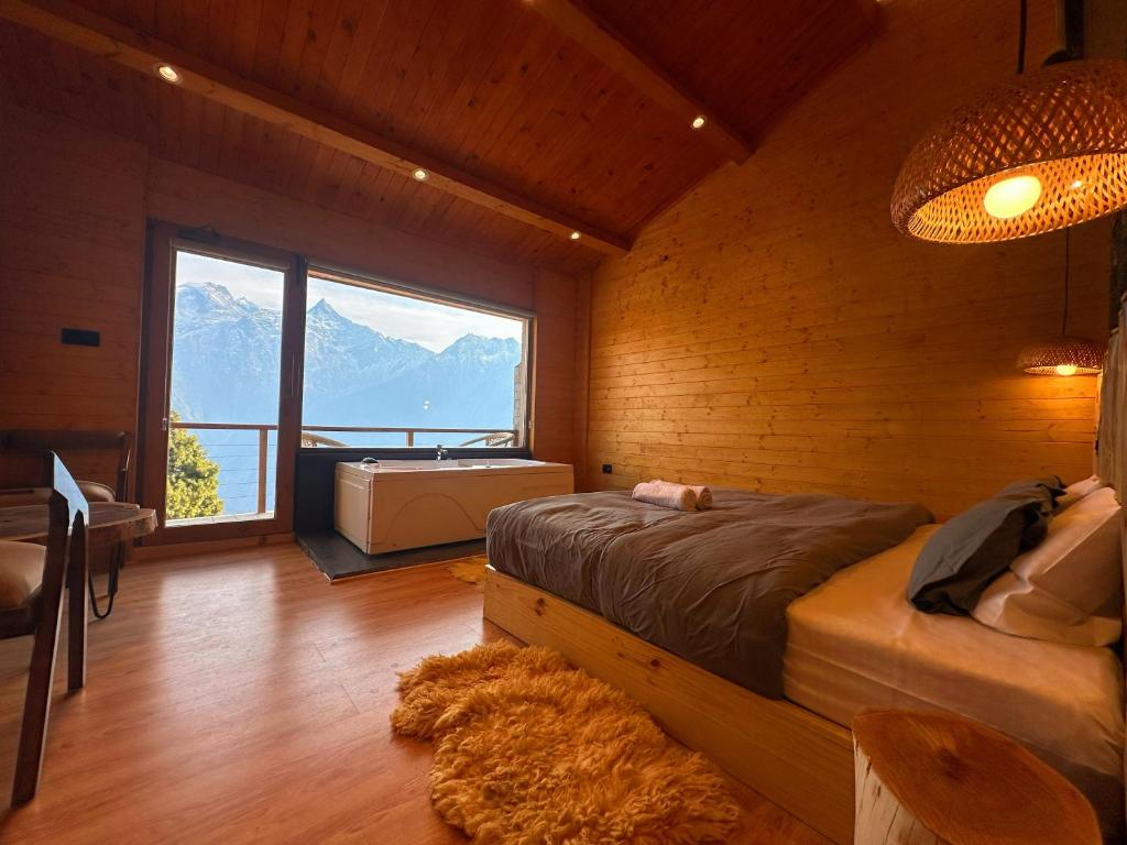 a bedroom with a bed and a tub and a window at FAYUL RETREAT - India Highest Glamp and EcoLuxury Stay in Kalpa