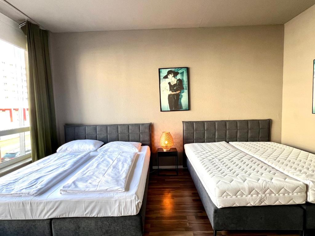 Postel nebo postele na pokoji v ubytování N8 ROOMS - by Leipzig Suites