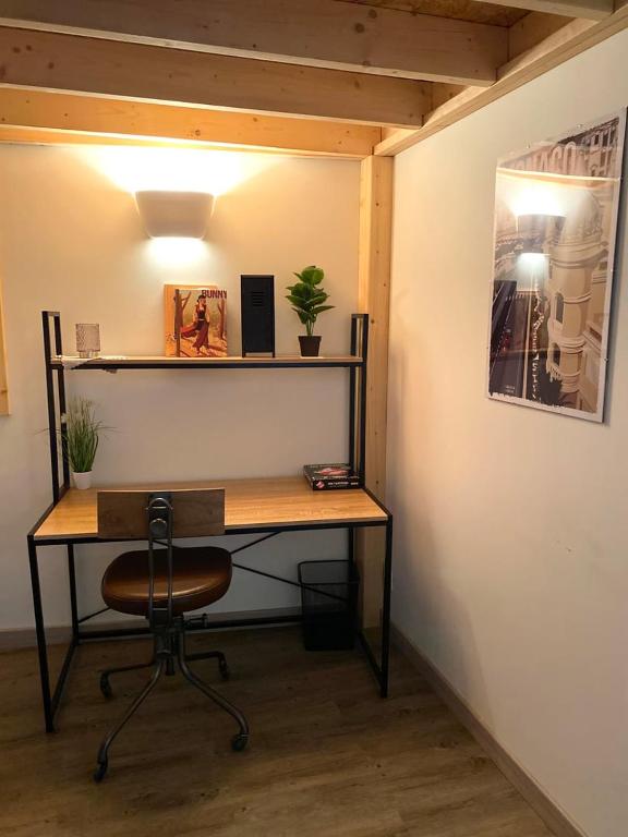 a desk with a chair next to a wall at Le Descartes: cosy in the city centre in Poitiers