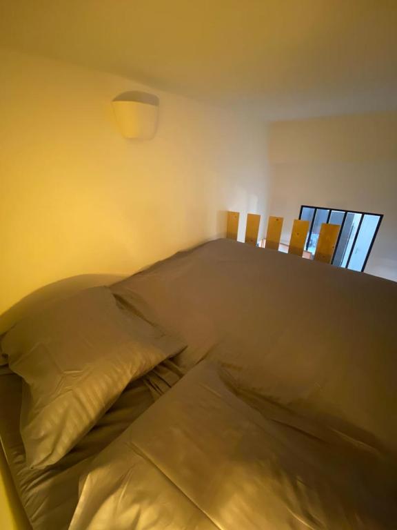 a bedroom with a bed with two wooden chairs at Le Descartes: cosy in the city centre in Poitiers