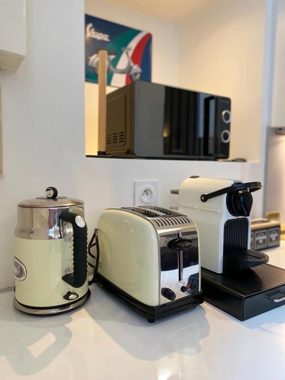 a kitchen counter with a toaster and a toaster and a toaster at Le Descartes: cosy in the city centre in Poitiers