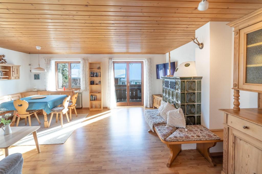 a living room with a blue table and a dining room at Fewo Simone in Rettenberg