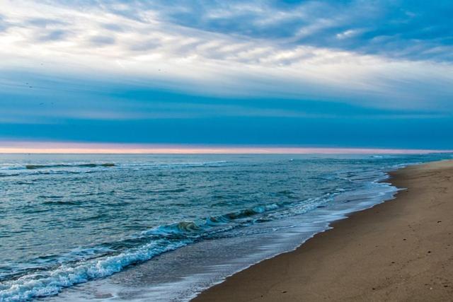 a beach with the ocean and a cloudy sky at See to Sea Apartments 2 in Paralia Dionysiou