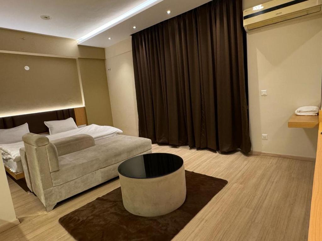 a hotel room with a bed and a chair at ARMERIA STAY 309 in Lucknow