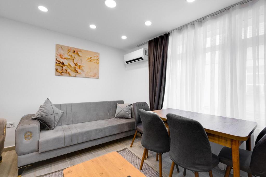 a living room with a couch and a table at Cozy Flat 10 min to Marmaray and Uskudar Coast in Istanbul